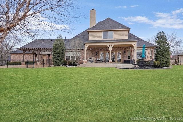 back of property featuring a patio, a yard, and a pergola