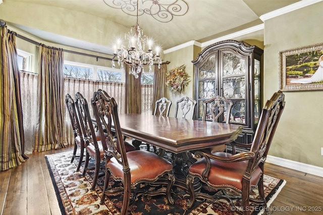 dining space featuring crown molding, dark hardwood / wood-style floors, and a chandelier