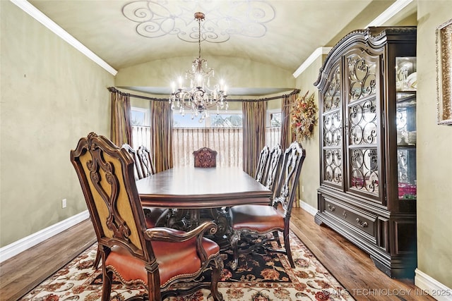 dining space with lofted ceiling, wood-type flooring, and a notable chandelier