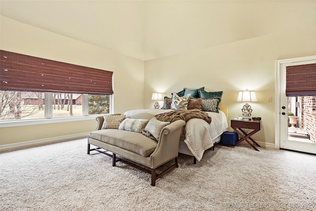 bedroom featuring light colored carpet and access to exterior