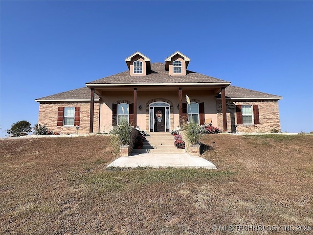 view of front of house featuring a front yard and covered porch