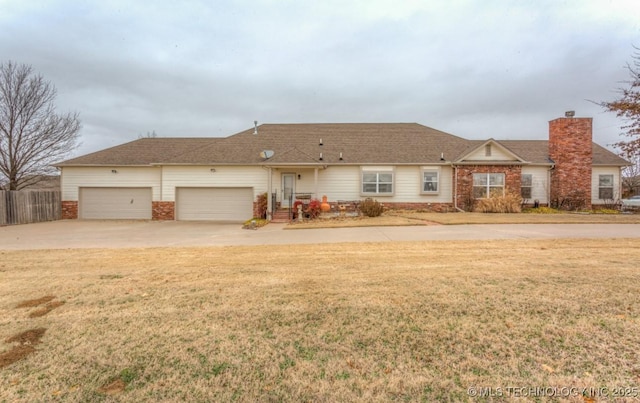 ranch-style house with a garage and a front lawn