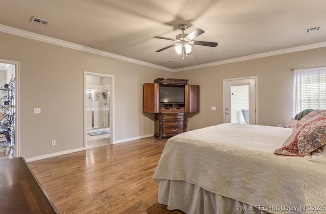 bedroom featuring hardwood / wood-style flooring, ceiling fan, crown molding, and ensuite bath