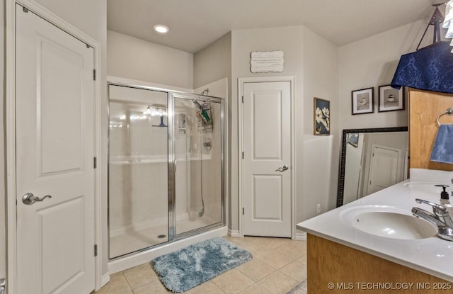 bathroom with tile patterned floors, an enclosed shower, and vanity