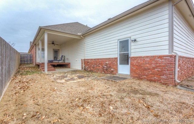 rear view of property featuring ceiling fan