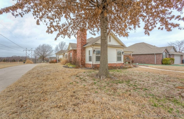 view of side of home with a garage and a yard