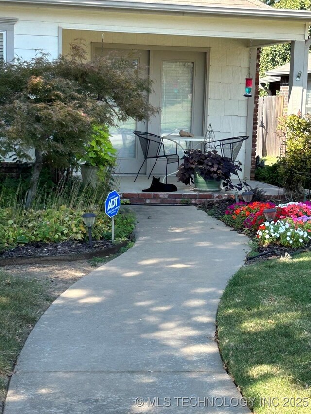 view of exterior entry with a porch