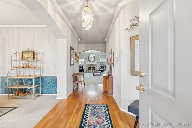 foyer entrance with crown molding and hardwood / wood-style flooring