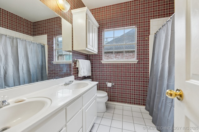 bathroom featuring tile patterned flooring, vanity, plenty of natural light, and toilet