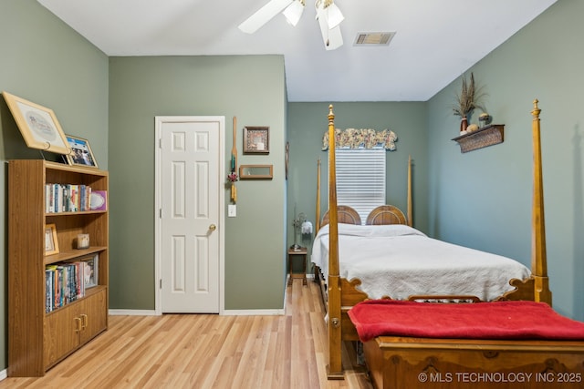 bedroom with ceiling fan and light hardwood / wood-style floors