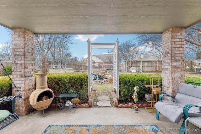 view of patio with exterior fireplace