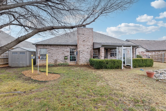 back of property featuring a lawn and a storage shed