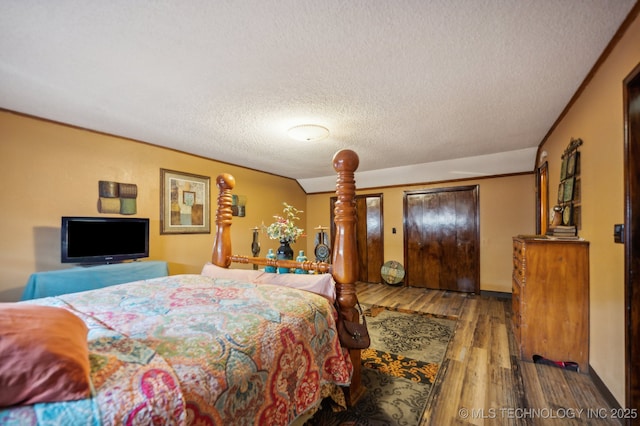 bedroom with hardwood / wood-style flooring and a textured ceiling