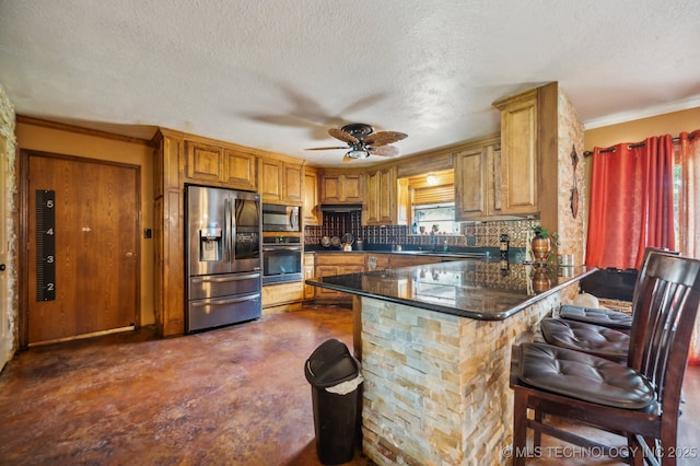 kitchen with sink, a breakfast bar, appliances with stainless steel finishes, decorative backsplash, and kitchen peninsula