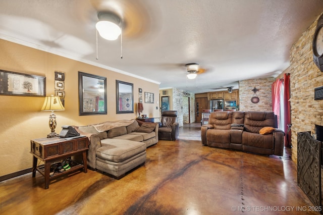 living room featuring concrete flooring, a stone fireplace, a textured ceiling, ornamental molding, and ceiling fan