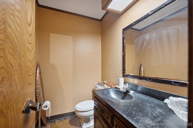 bathroom featuring ornamental molding, toilet, and vanity