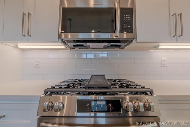 kitchen featuring tasteful backsplash, stainless steel appliances, and white cabinets