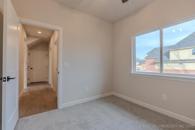 unfurnished room featuring light carpet