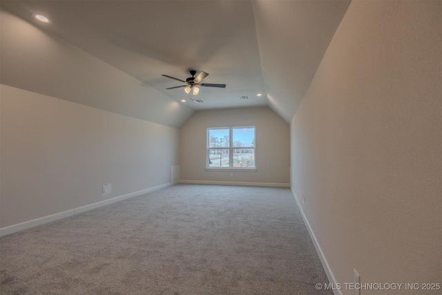 bonus room with vaulted ceiling, light carpet, and ceiling fan