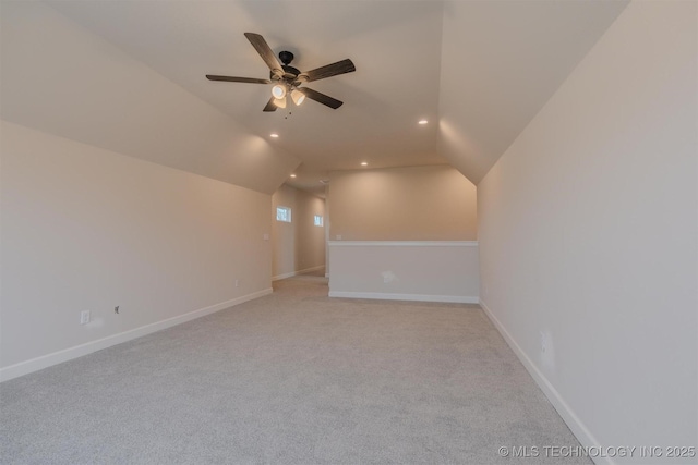 bonus room featuring ceiling fan, light colored carpet, and lofted ceiling