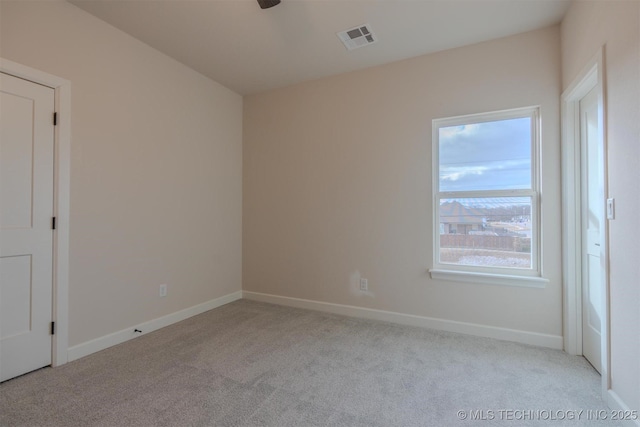 carpeted spare room with ceiling fan