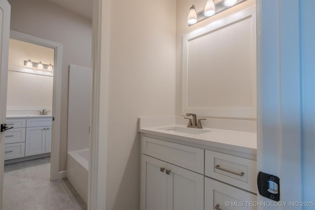 bathroom featuring vanity and a bath