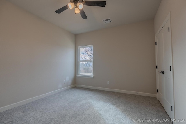 unfurnished room featuring light colored carpet and ceiling fan