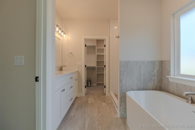 bathroom with vanity and a bath