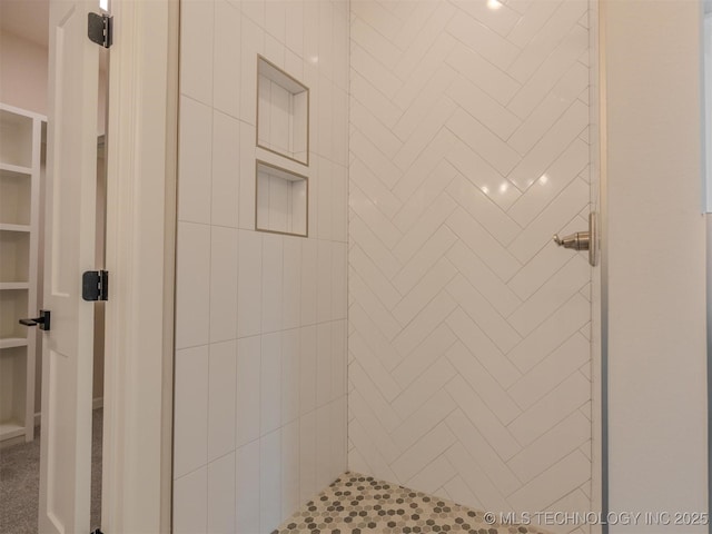 bathroom featuring tiled shower