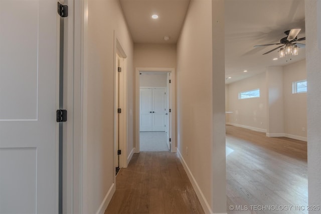 corridor with light hardwood / wood-style floors