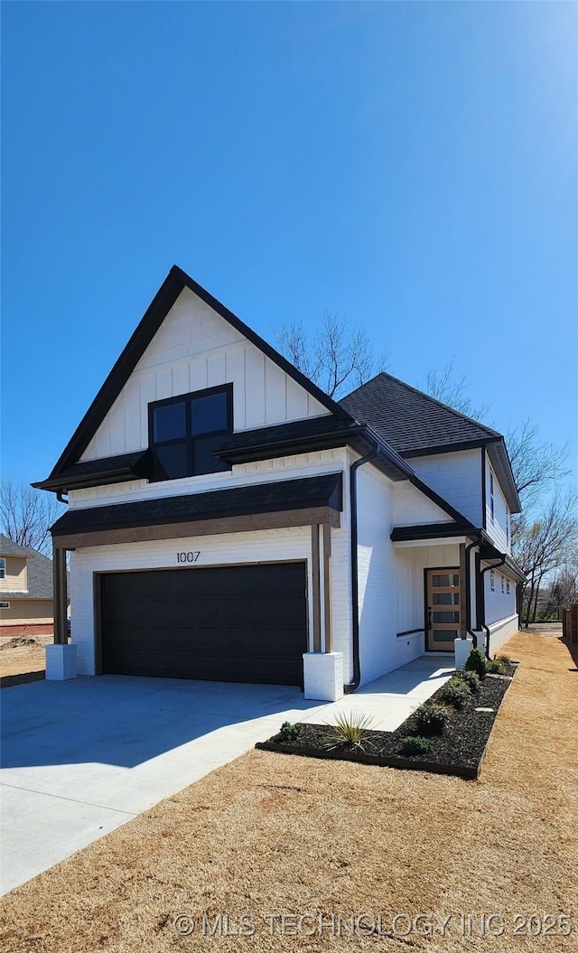 view of front facade featuring board and batten siding and concrete driveway