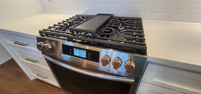 kitchen view of gas range and decorative backsplash