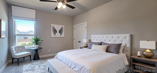 carpeted bedroom featuring multiple windows, baseboards, and ceiling fan