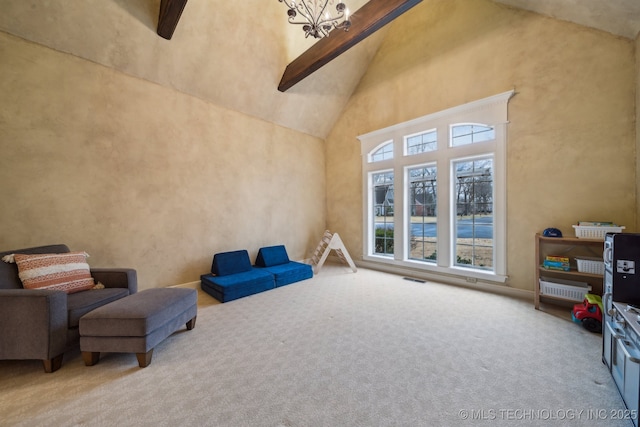 sitting room with carpet floors, high vaulted ceiling, and beamed ceiling