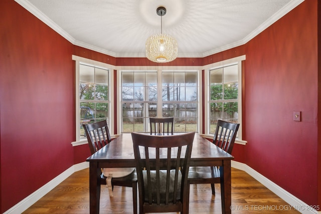 dining room with crown molding and dark hardwood / wood-style floors