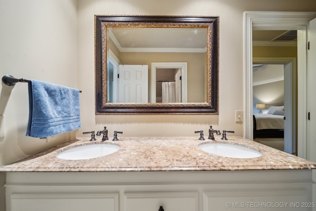 bathroom with crown molding and vanity