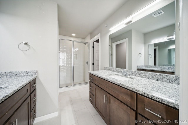 bathroom featuring tile patterned floors, vanity, and an enclosed shower