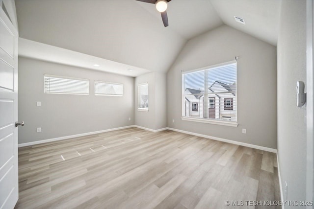 spare room with vaulted ceiling, ceiling fan, and light hardwood / wood-style floors