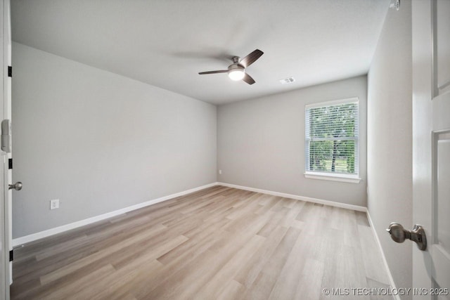 spare room featuring ceiling fan and light wood-type flooring