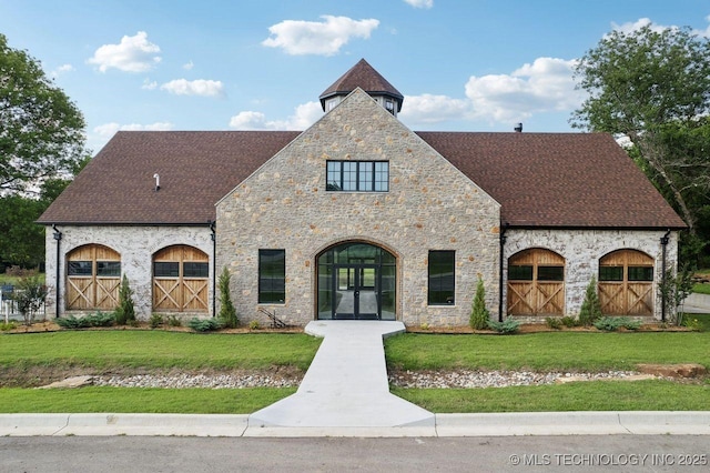 view of front of house featuring a front lawn and french doors