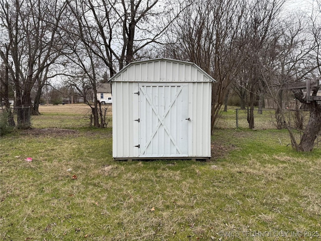 view of outbuilding with a yard