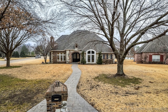 view of front of house featuring a front lawn and french doors