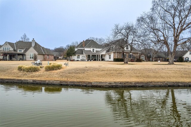 back of house featuring a water view