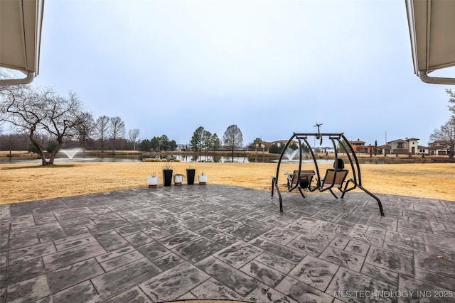 view of jungle gym with a water view and a patio