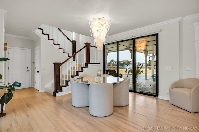 living room featuring ornamental molding, a chandelier, and wood-type flooring