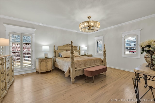 bedroom featuring an inviting chandelier, multiple windows, light hardwood / wood-style flooring, and crown molding