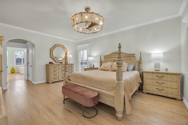 bedroom featuring light wood-style flooring, arched walkways, a chandelier, and baseboards