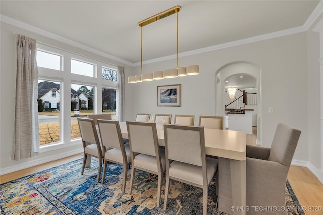 dining room featuring hardwood / wood-style flooring and ornamental molding