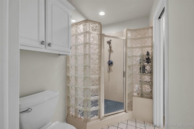 bathroom with toilet and a shower with door