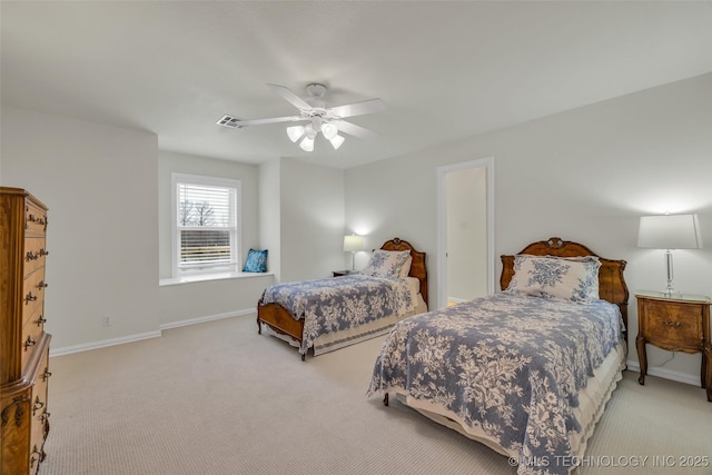 carpeted bedroom featuring a ceiling fan, visible vents, and baseboards